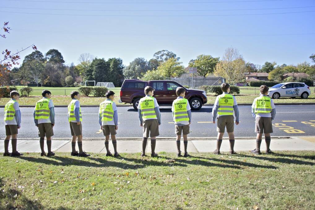 Canberra Grammar students, from left, Lachlan Bugden (14), Oliver Hansen (11), Will Madl (11), Tristan Ho (12), Logan Bertles (11), Fergus Pandy (12), James Frey (11) and Bryce Junk-Gibson (11) prepare for Walk Safely To School Day. 