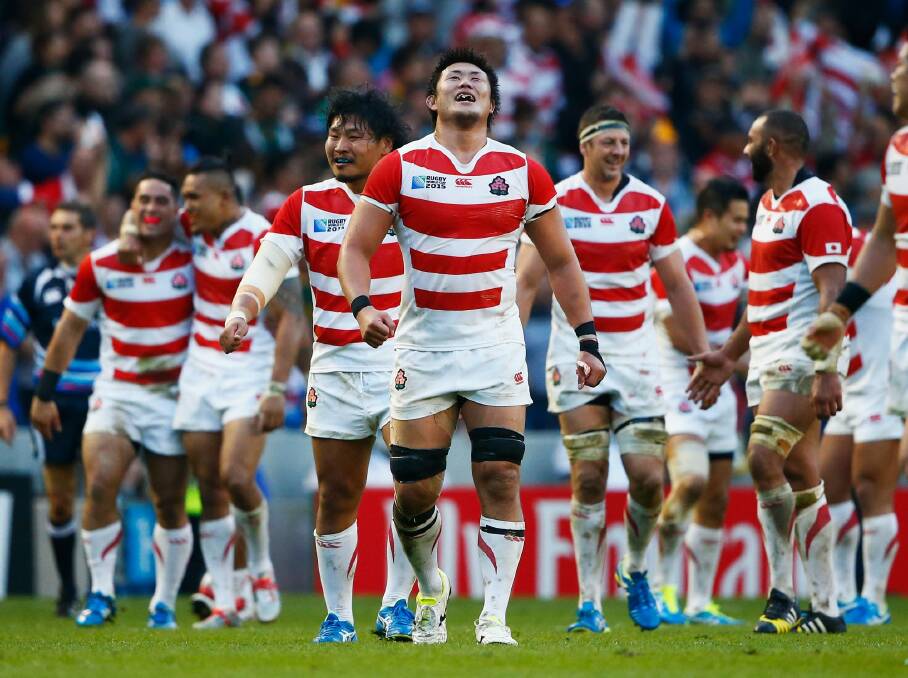 Japan players celebrate their surprise victory against South Africa. Photo: Julian Finney