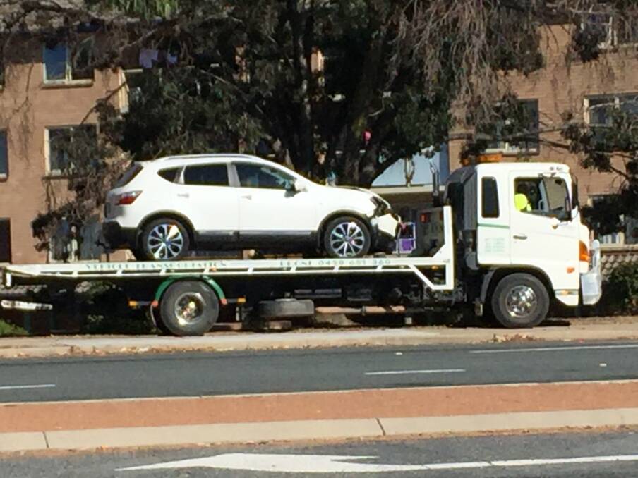 A car sits on a tow truck after a two-vehicle crash in Phillip on Wednesday morning. Photo: Blake Foden