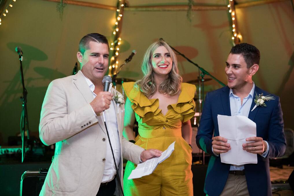 Corinne Mulholland (centre) was MC at the wedding of Shane Newcombe (left) and Ethan Tyler (right). Photo: Supplied