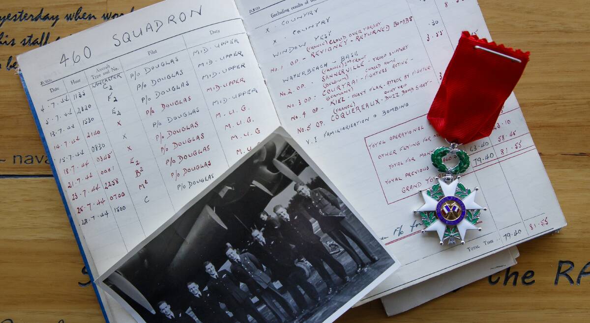 Ken Willis, second from right, is seen in a photo of 460 Squadron, along with a log book showing the missions he flew over France, and the Legion of Honour medal he was awarded in 2018.  Photo: Sitthixay Ditthavong