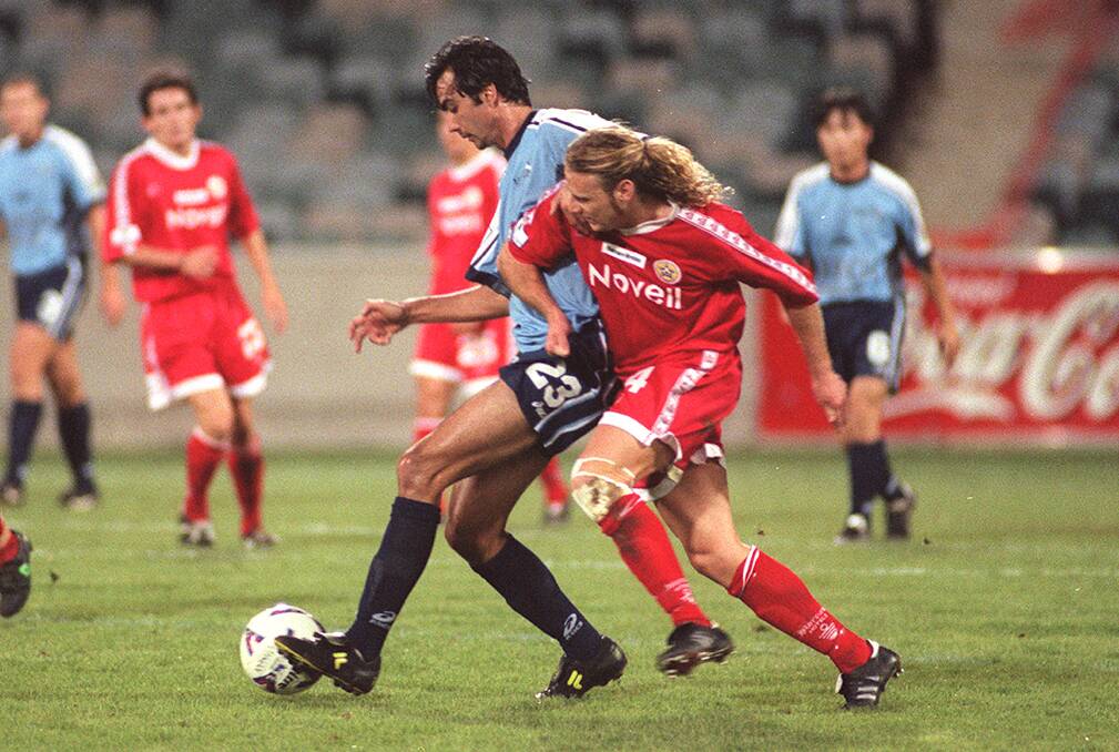 Paul Roberts, in red, played for the Canberra Cosmos from 1998-2000. Photo: Kate Callas