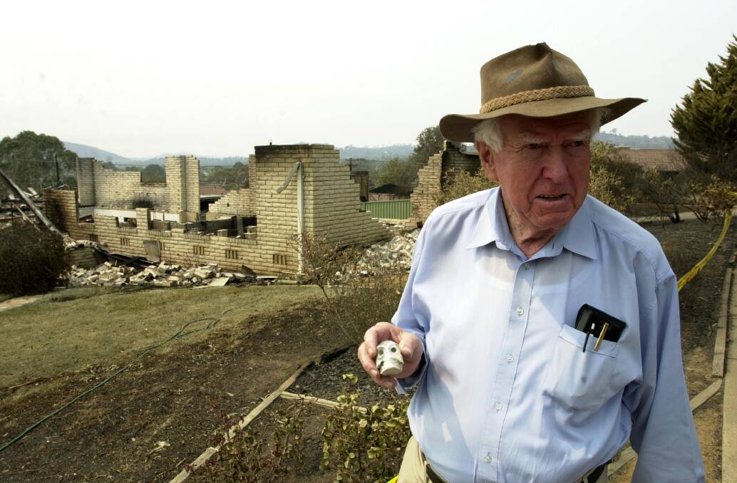  Sir Peter Lawler holds up a small skull, the only thing to be salvaged from his Duffy home destroyed by the 2003 firestorm.  Photo: Lannon Harley