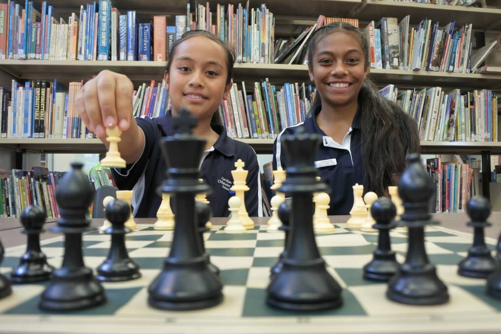Sisters Imogen and Nicole Vea are following in their older siblings' footsteps, taking part in a national chess tournament with other students from Caroline Chisholm School. Photo: Stephen Jeffery