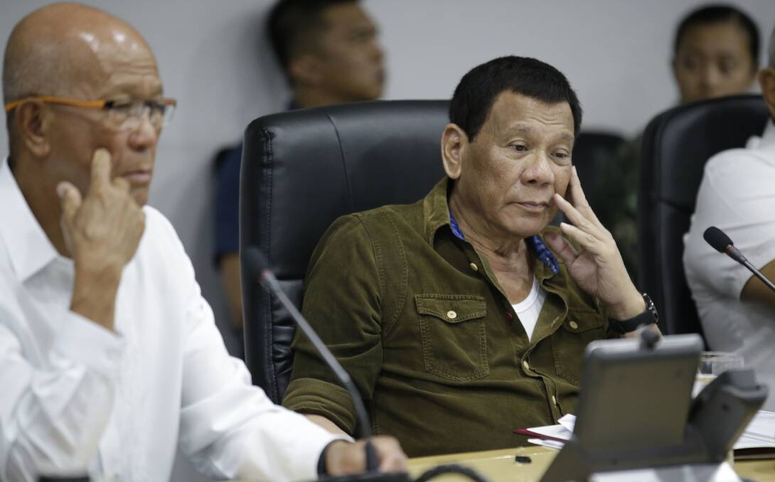 Philippine President Rodrigo Duterte, centre, and Defence Secretary Delfin Lorenzana, left, attend a command briefing on typhoon Mangkhut. Photo: AP
