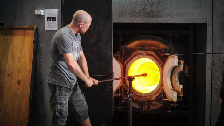 Glass artist Brian Corr at work at the Canberra Glass Works. Photo: Katheirne Griffiths