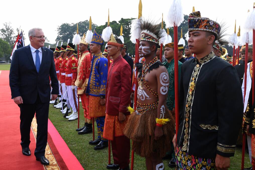 Scott Morrison inspects a guard of honour at Bogor Presidential Palace near Jakarta on Friday. Photo: AAP