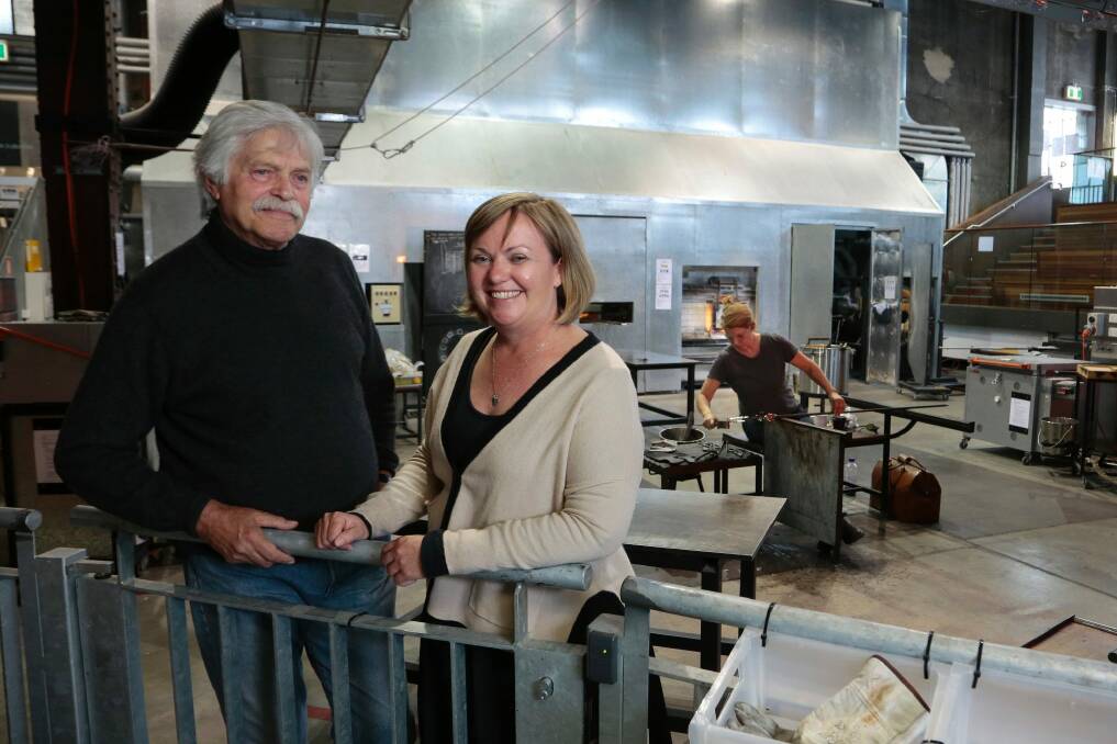 Canberra Glassworks founder Klaus Moje with general manager Beverly Growden as artist Sophia Emmett works in the hotshop. Photo: Jeffrey Chan