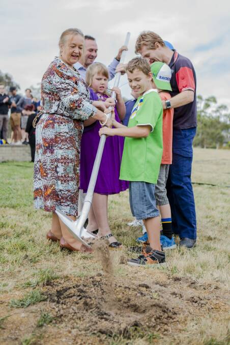 Under way: Joy Burch, Ricky Stuart, and children with disability turn the first sod on a new respite centre. Photo: Jamila Toderas