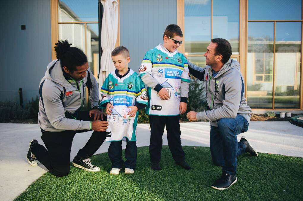 Sia Soliola and Ricky Stuart meet with Jayden, 8, and Max, 12, to give them the special jerseys they helped design. Photo: Rohan Thomson