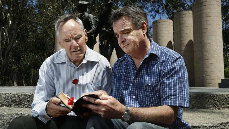 John Morgan and Darryl Johnston look at a bible that belonged to John's great uncle who was engaged to Darryl's great aunt. Photo: Jeffrey Chan