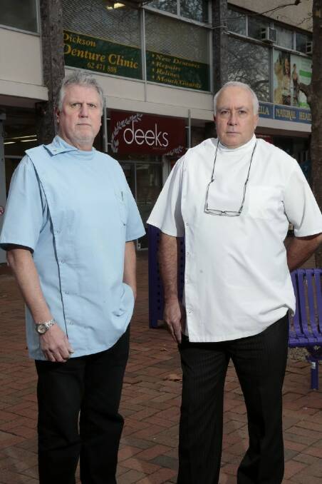 Paul Weber and Garry McDonald from the Dickson Denture Clinic are angered about the loss of customer carparks for their aged patients close to their practice during the redevelopment of the Woolworths carpark. Photo by Jeffrey Chan.