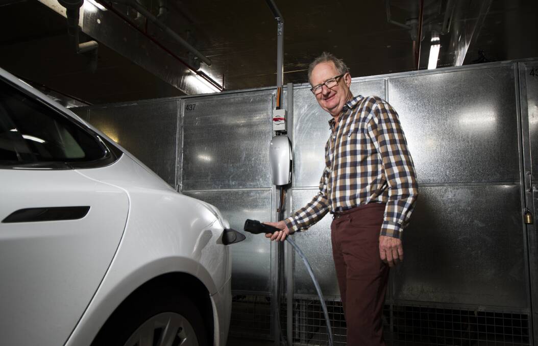 Darryl Bourke, with his Tesla electric vehicle, is happy new charging stations will appear in the ACT and NSW. Photo: Elesa Kurtz