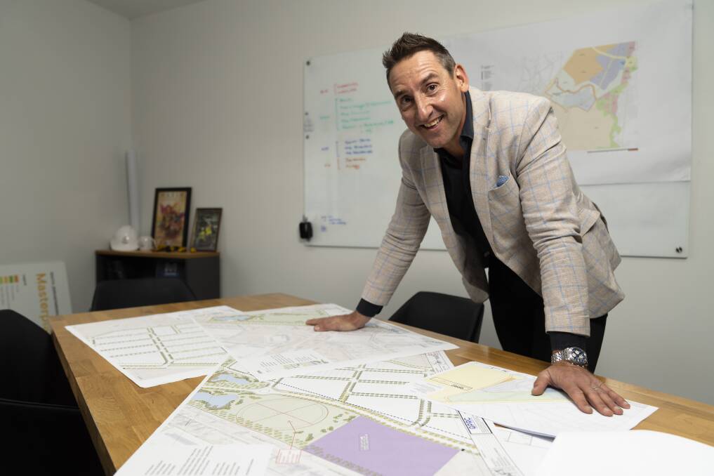 Village Building Company chief executive Travis Doherty with the master plans for the South Jerrabomerra Estate.  Photo: Lawrence Atkin