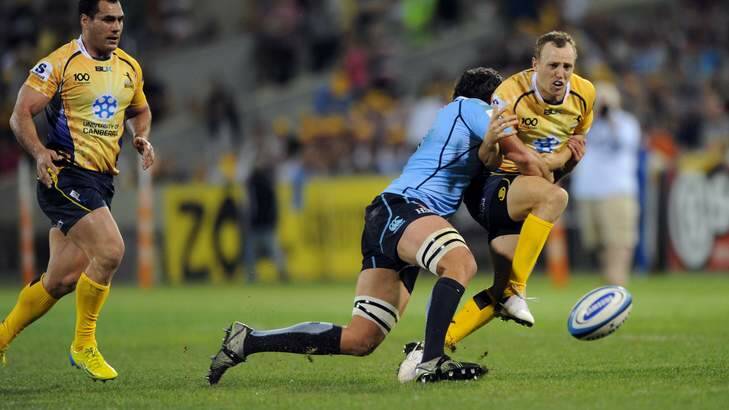 Brumbies fullback Jesse Mogg gets tackled against the Waratahs. Photo: Graham Tidy