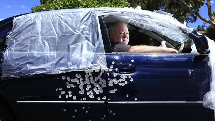 Graham Wilson sits in his car which was involved in a drive by shooting in Canberra. Photo: Katherine Griffiths