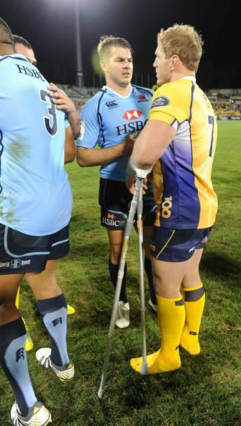 Drew Mitchell  and an injured David Pocock chat after the Waratahs Brumbies clash on Saturday. Photo: Graham Tidy