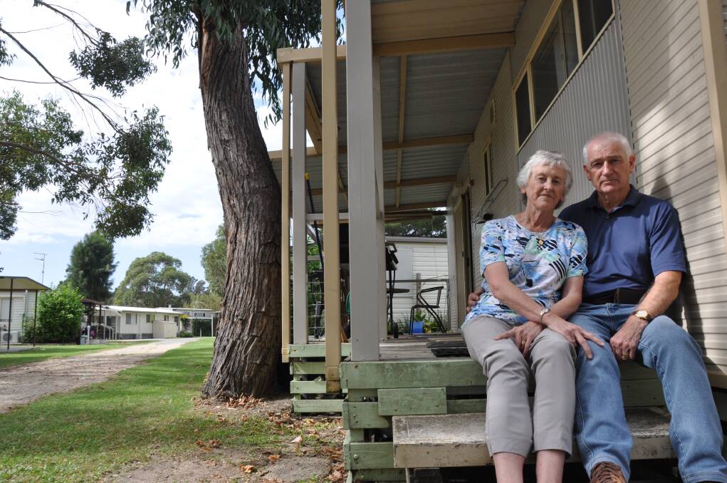 Canberra couple Elizabeth and Robin Turnbull outside their cabin, which they will soon be forced to remove from Tomaga River Holiday Park if a proposed redevelopment goes ahead. Photo: Kerrie O'Connor/Batemans Bay Post
