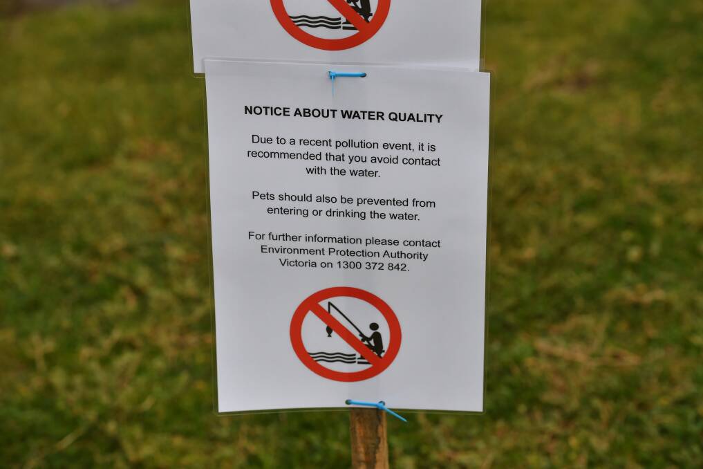 Melbourne Water employees put up warning signs at the Warmies around 5pm. Photo: Joe Armao