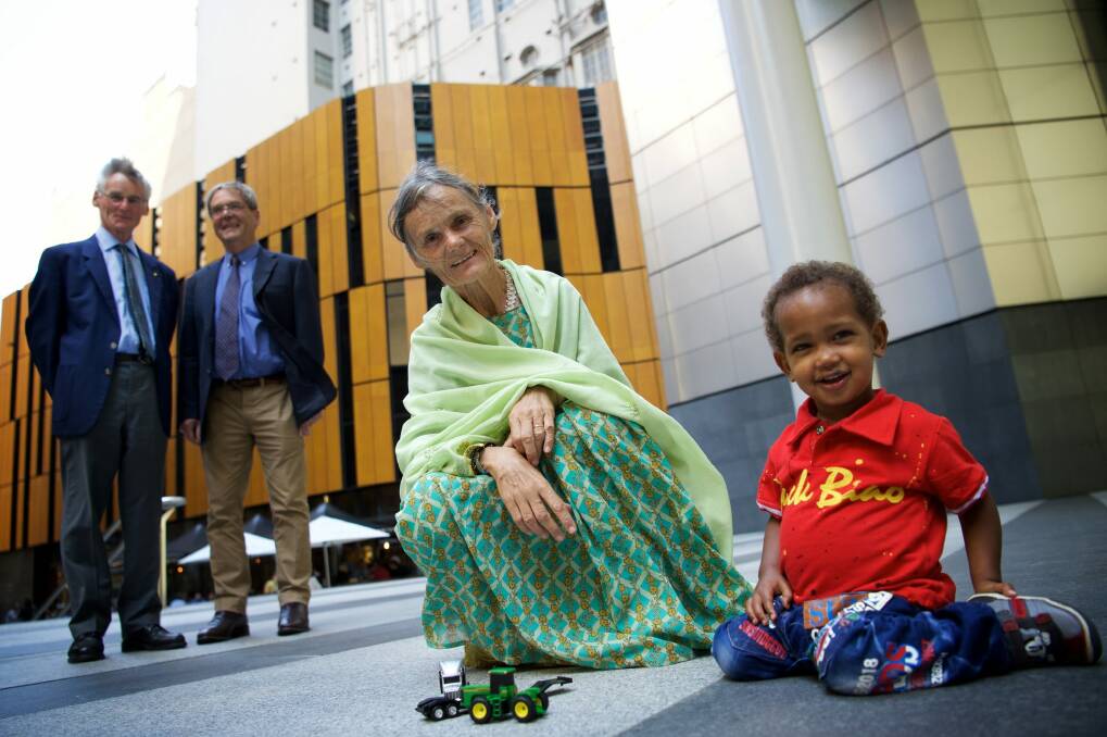 Australian nurse Valerie Browning in Sydney this week with her two-year-old adopted son Nabil. Looking on are her brothers David and George Browning. Photo: Wolter Peeters
