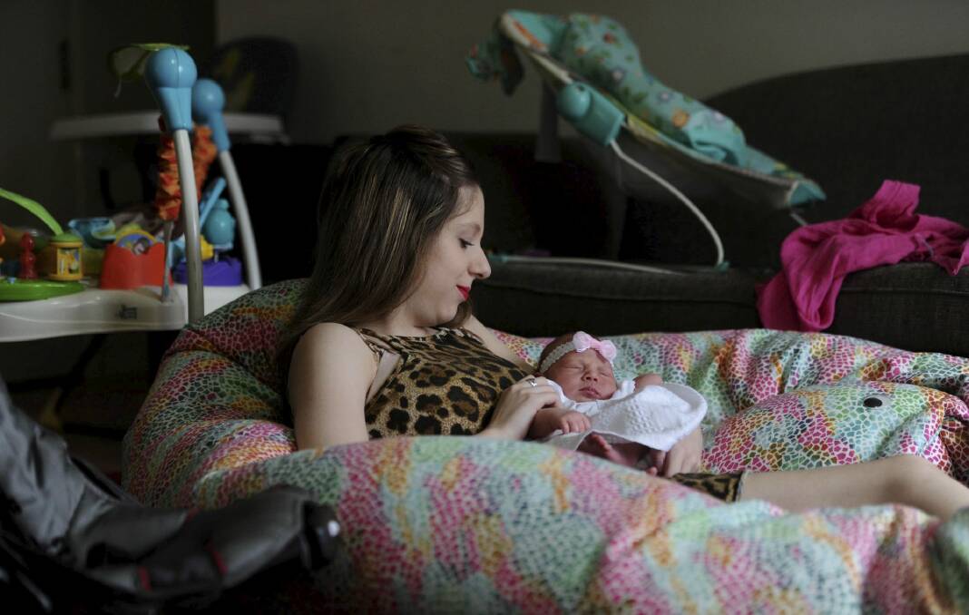 Taylor, 16, with her 13-day-old daughter, Aaliyah, at Erin House, one of two homes in north Canberra run by Karinya House for vulnerable pregnant women and new mothers. Photo: Graham Tidy