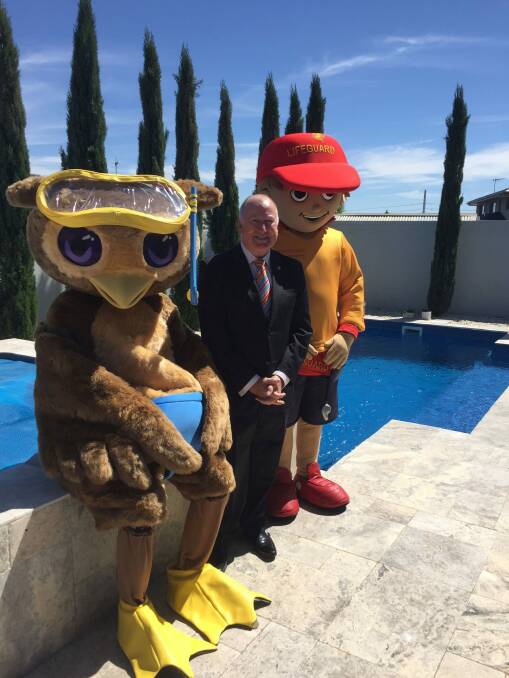 ACT Minister for Planning and Land Management Mick Gentleman with mascots from the Royal Life Saving Society and Kids Alive promote a new campaign to raise pool safety awareness. Photo: Karen Hardy