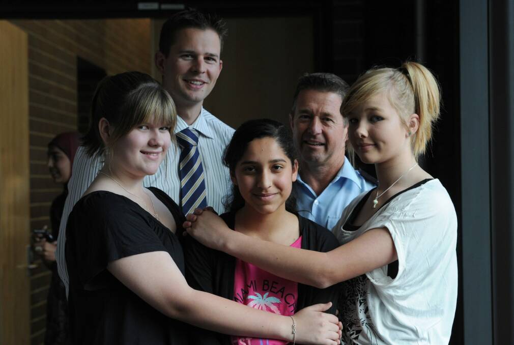Drowning survivor Zartash Sarwar, 13, of Palmerston, flanked by two of her rescuers, Constable Paul Reynolds, rear left, and firefighter Neil Maher, and her friends Tessa Blight, 13, of Palmerston, left, and Emily de Gier, 14, of Forde, at a ceremony after the incident in December 2012. Photo: Graham Tidy