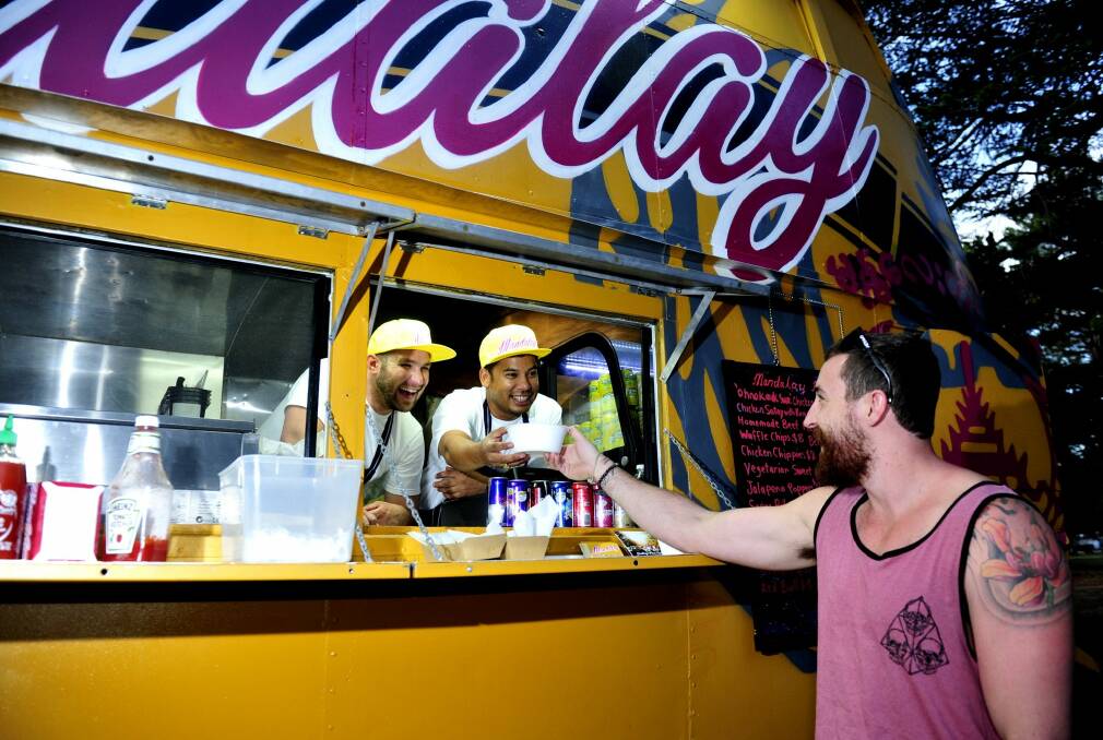 Chris Baxter enjoys a meal from Andrew Hollands and Stewart Thaung at The Mandalay bus last year. Photo: Melissa Adams