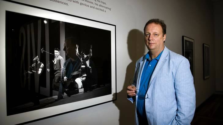 BEFORE THE KING WAS CROWNED: Smithsonian National Portrait Gallery researcher Warren Perry with one of the portraits from Elvis at 21. Photo: Elesa Kurtz