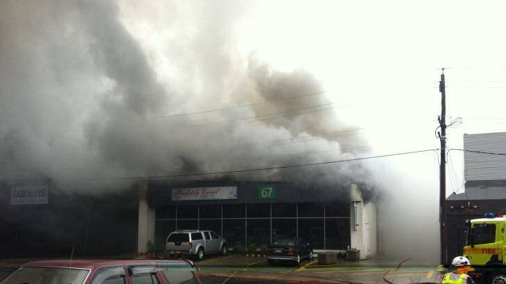 Toxic fumes: Smoke pours from the building in Gladstone Street, Fyshwick, on Tuesday. Five people suffered  from minor smoke inhalation as a result of the fire. Photo: Primrose Riordan