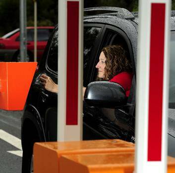 University of Canberra employee Melanie Kovacs drives through one of the boom gates which have been installed in the tertiary institution's southern car parks. Photo: STUART WALMSLEY