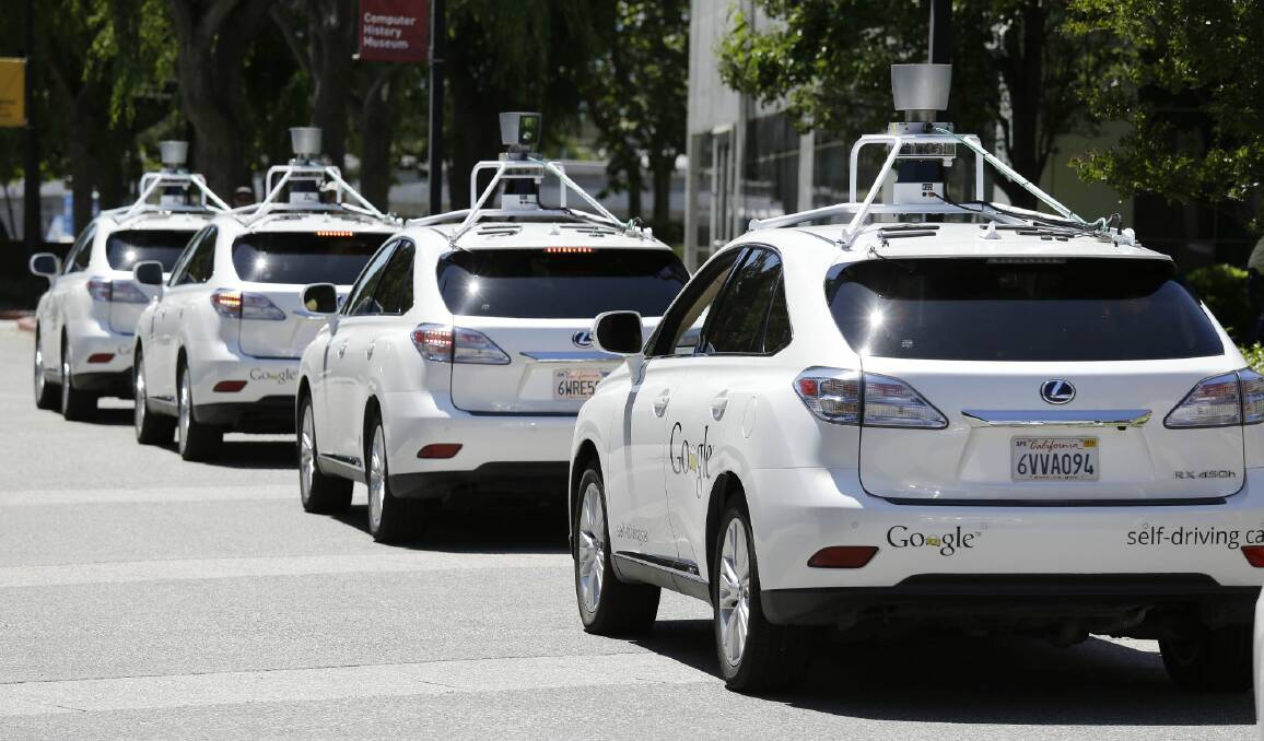 A row of Google self-driving cars stands outside the Computer History Museum in Mountain View, California. Photo: Eric Risberg