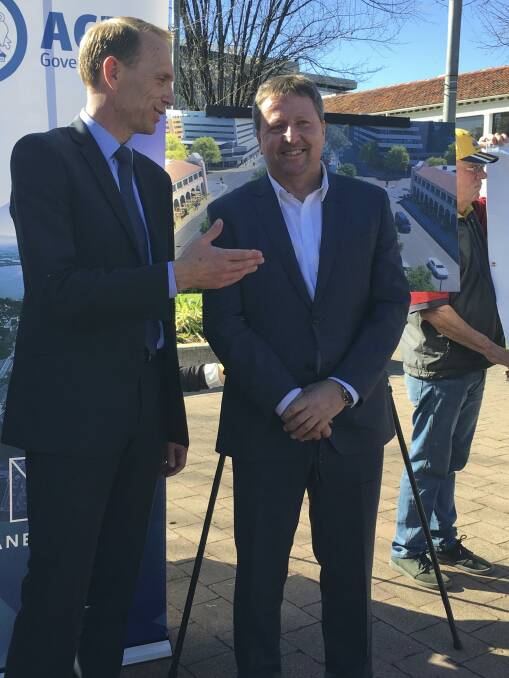 Capital Metro Minister Simon Corbell with Canberra Metro consortium chief executive Martin Pugh on Tuesday. Can the Tram protester David Dickson is in the background. Photo: Kirsten Lawson