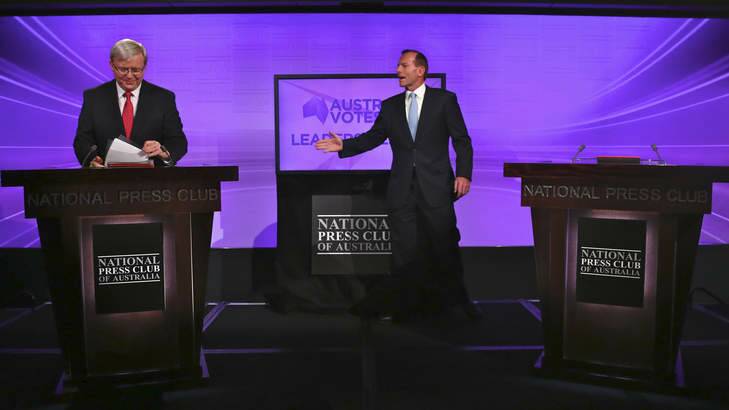 Prime Minister Kevin Rudd appears to read notes as Opposition Leader Tony Abbott notices moments before last Sunday's debate. Photo: Andrew Meares