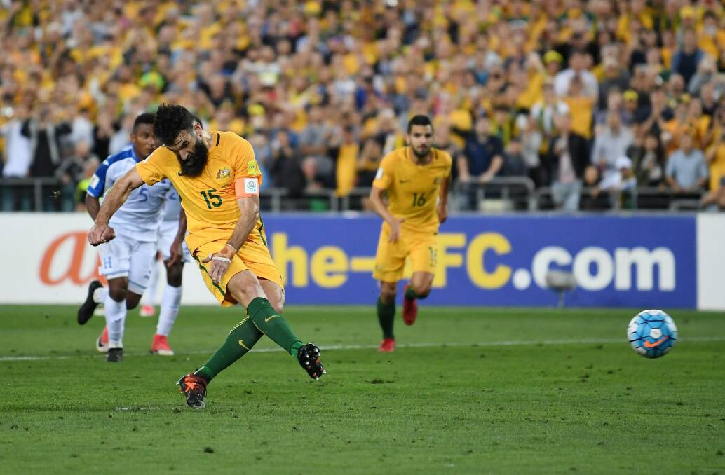 Mile Jedinak scores from the penalty spot the first time around. Photo: AAP