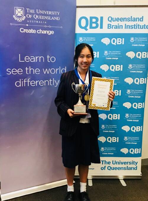 Jennifer Mai shows off her trophy as the 2018 Queensland Brain Bee champion. Photo: Alison Brown