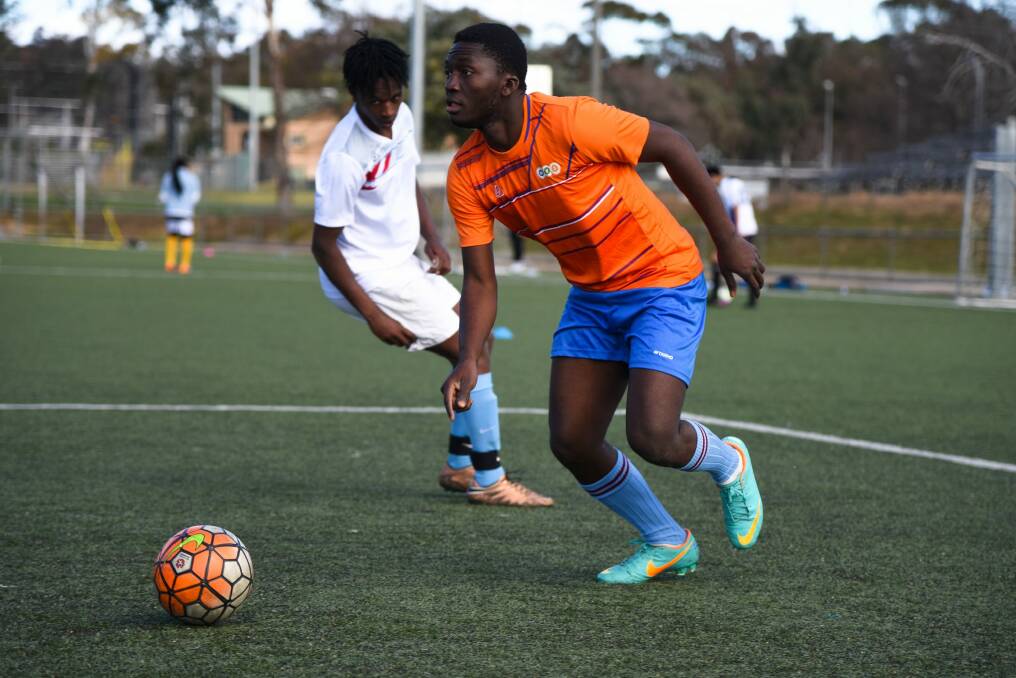 Members of Canberra's refugee, immigrant and asylum seeker community take part in the Refugee Week World Cup in Belconnen, Canberra. Sierra Leone All Stars versus the Multicultural Youth Services All Stars. Photo: Finbar O'Mallon