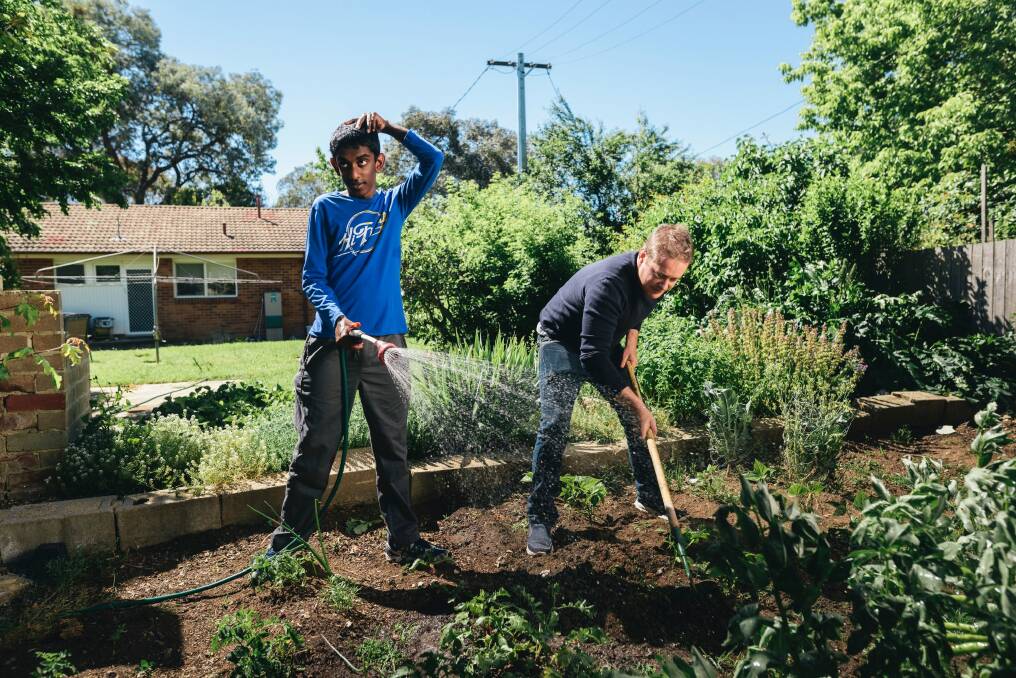 Rashmika Pathmaperuma and Ben Lane working in the garden. Rashmika, 16, has Fragile X Syndrome as well as austism and intellectual imparement, and Ben Lane has been nominated in the Chief Minister's Inclusion Awards. Photo: Rohan Thomson