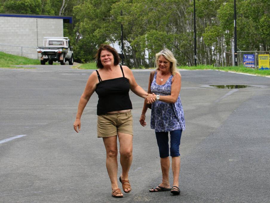 Sandra Roome (left) and Christine Landy comfort each other as the family waits for news. Photo: Jorge Branco.