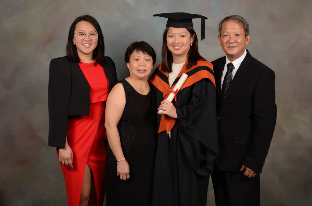 The Nguyen family. Fairfax reporter Han Nguyen, third left, with her sister Duyen, mum Chi and dad Sang at her graduation in May.  Photo: Supplied