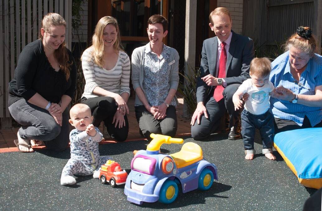 Deanne Kuhn, of Bonner, (far left) and her seven month son Ethan, with Health Minister Simon Corbell and midwives Vanessa Bakker (centre) and Marguarita van Oosten, holding Reya, eight months, at the QEII Family Centre in Curtin on Friday. Photo: Supplied