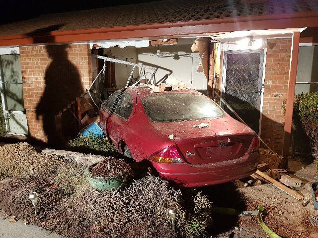 A car rests in the front of the home of newlyweds Catia Ochi and Colin Tucker on Deamer Crescent, Richardson, on Wednesday morning. Photo: Supplied