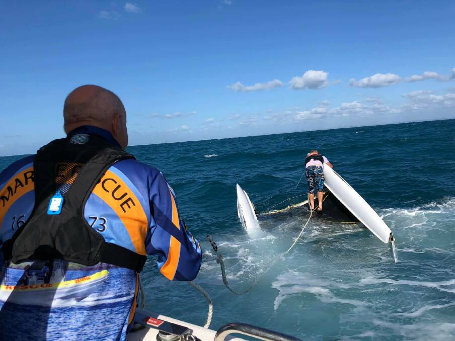 The marine rescue boat managed to tow the stricken catamaran back to shore, despite the rough seas and strong winds. Photo: Volunteer Marine Rescue Hervey Bay - Facebook