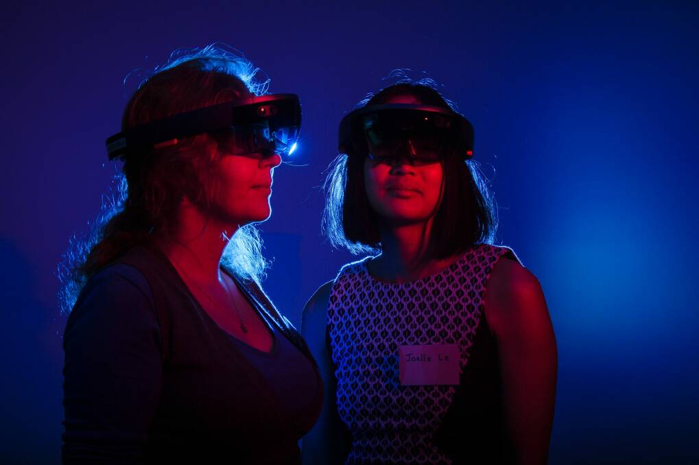 Educational designer Leah Holroyd and educational designer/technologist Joelle Le demonstrate Microsoft HoloLens.  Photo: Sitthixay Ditthavong