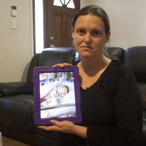 NSW mother Cherie holding a picture of her daugher, who can no longer get medical marijuana Photo: ABC News