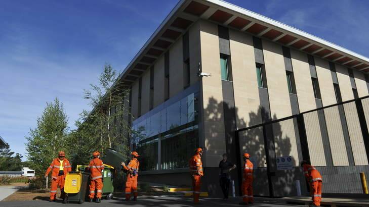 Members of the ACT SES attend a job at the Royal Australian Mint, where a sudden wind storm lifted tiles from the roof and sent debris crashing into cars. Photo: Graham Tidy