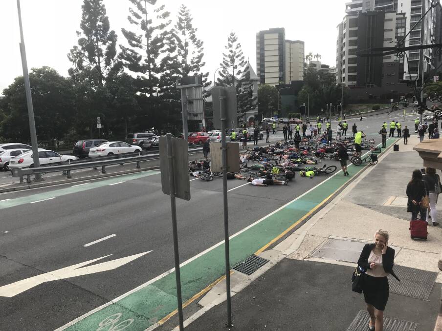 Cyclists stage the "die-in" protest during Brisbane's peak hour traffic.