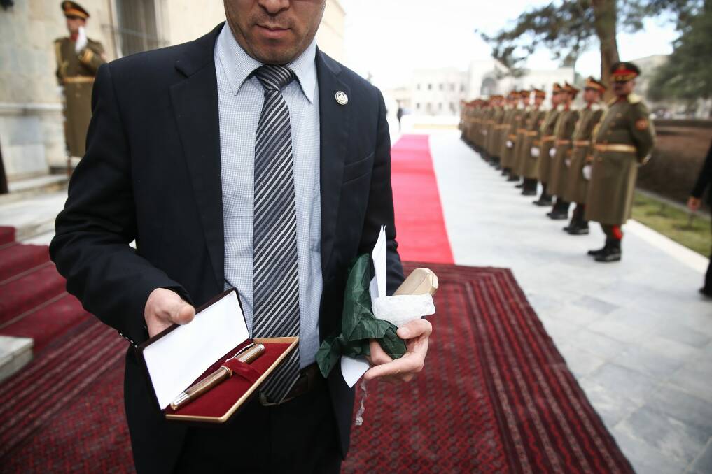 A staff member of the Presidential Palace holds the pen that Malcolm Turnbull presented to the President of Afghanistan, Ashraf Ghani during their meeting. Photo: Alex Ellinghausen