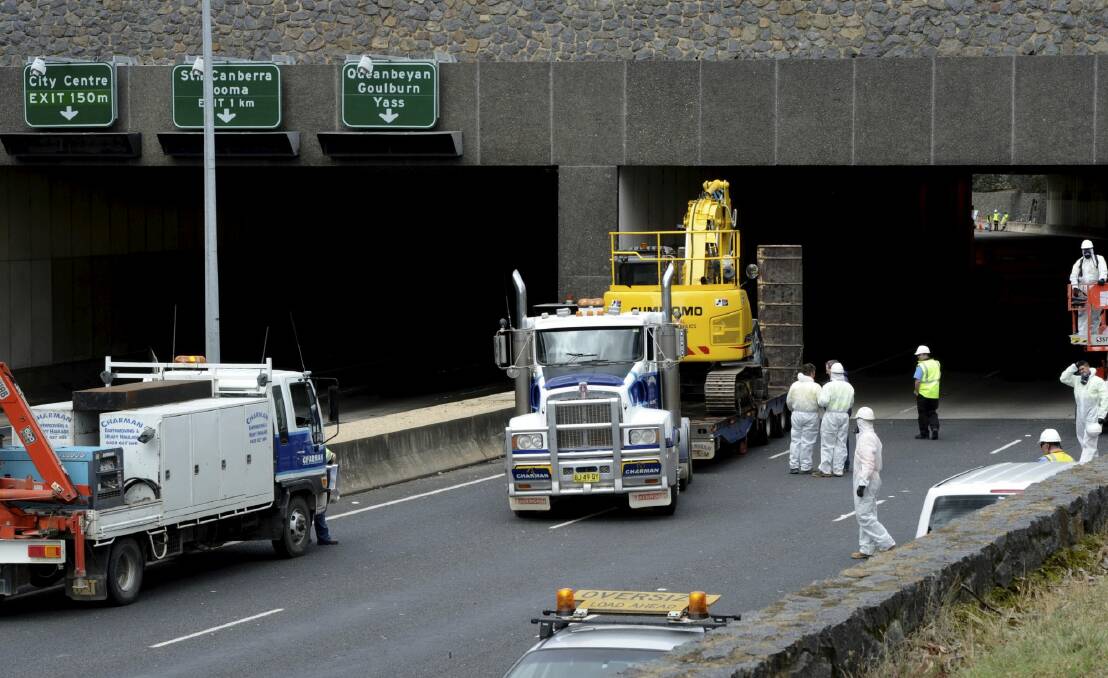 The truck and excavator are driven out of the Acton tunnel
on Parkes Way on October 22. Photo: Graham Tidy