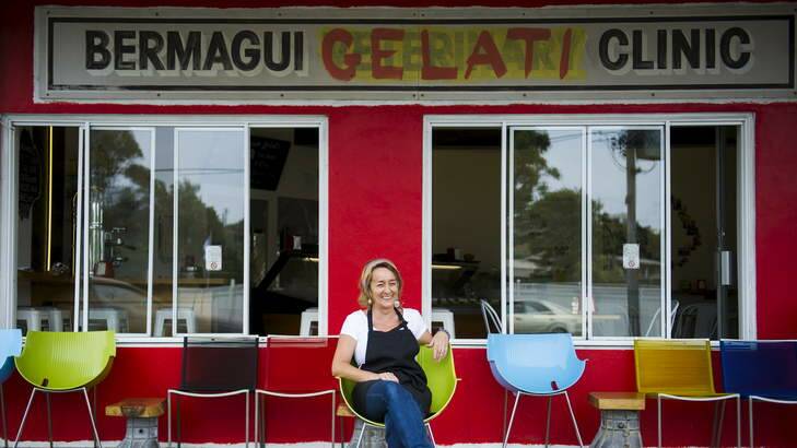 Mary Lurve, manager of Bermagui Gelati Clinic, in front of the repurposed 'Bermagui Veterinary Clinic' sign outside the store. Photo: Rohan Thomson